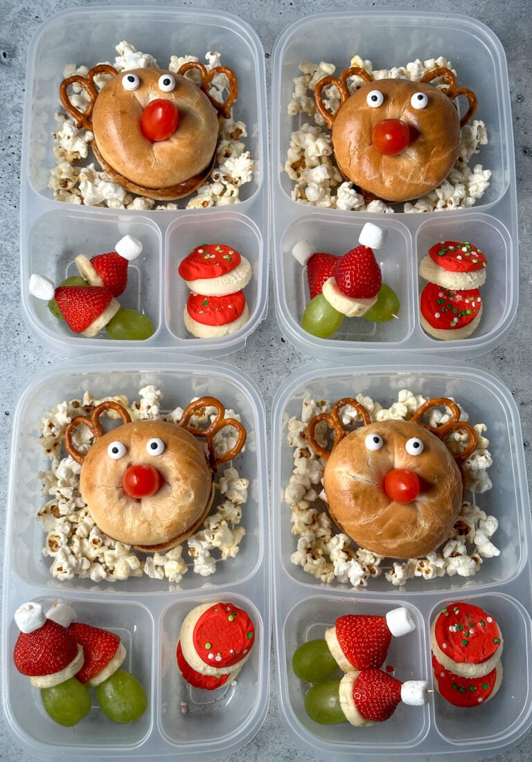 Reindeer bagel sandwich lunchboxes with pretzel antlers, cherry tomato noses and Grinch fruit kabobs