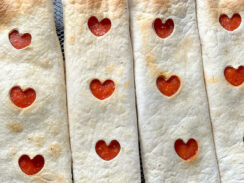 easy air fryer pizza wraps with pepperoni heart cut-outs down the center of the tortilla roll.