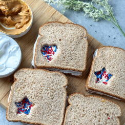 whole wheat fluffernutter sandwiches with heart and star cut-outs that are filled with red, white, and blue sprinkles