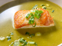 pan-seared sea bass in a coconut cilantro soup with diced green onions sprinkled on top