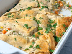 chicken pot pie made with crescent rolls in a white baking dish
