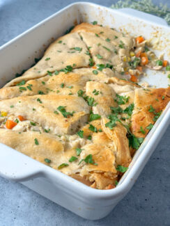 chicken pot pie made with crescent rolls in a white baking dish