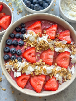 superfoods patriotic smoothie bowl topped with a design of the American flag created with blueberries, strawberries, bananas, coconut, and granola