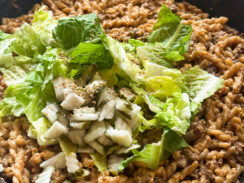 Big Mac cheeseburger pasta in a black skillet topped white shredded lettuce and pickles easy one pan meal