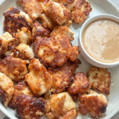 homemade chicken nuggets served with easy to make chick fil a dipping sauce on a round white serving dish