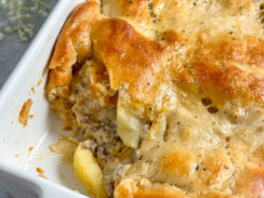 apple and sausage pie made with crescent rolls in a white baking dish