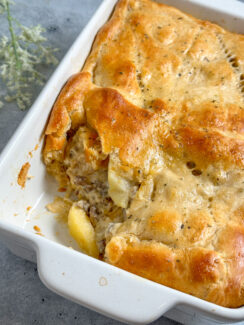 apple and sausage pie made with crescent rolls in a white baking dish