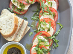 candy cane caprese made with layers of fresh mozzarella, tomatoes, shredded basil, and served with crusty bread and balsamic glaze.