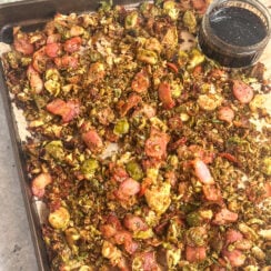 crispy bacon brussel sprouts perfect for the holidays on a sheet pan served with balsamic honey glaze