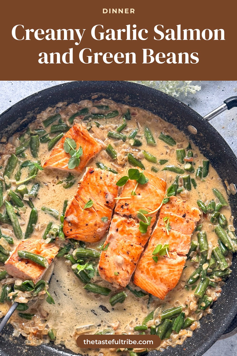 fork with a creamy garlic green bean sauce in a large black skillet
