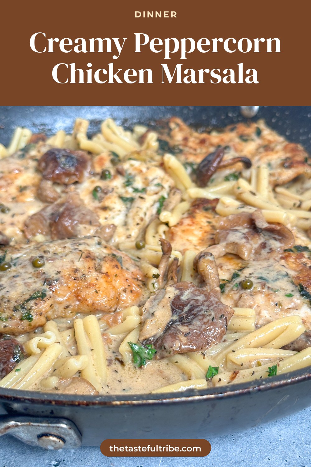 creamy chicken marsala with fresh peppercorns, the juiciest chicken, pasta, shiitake mushrooms in a black skillet
