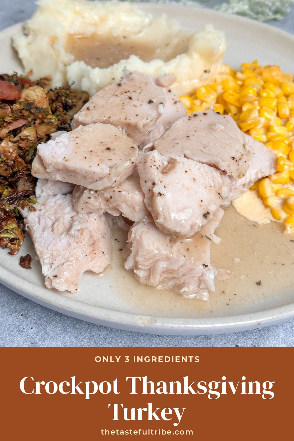 Sliced crockpot turkey breast on a plate with mashed potatoes and corn