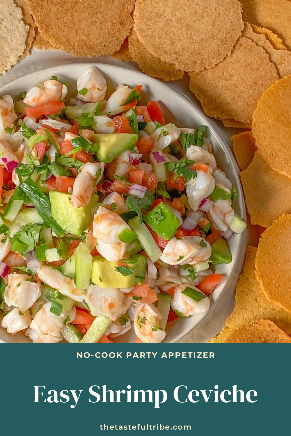 Bowl of shrimp ceviche with tomato, avocado and cilantro surrounded by tortilla chips