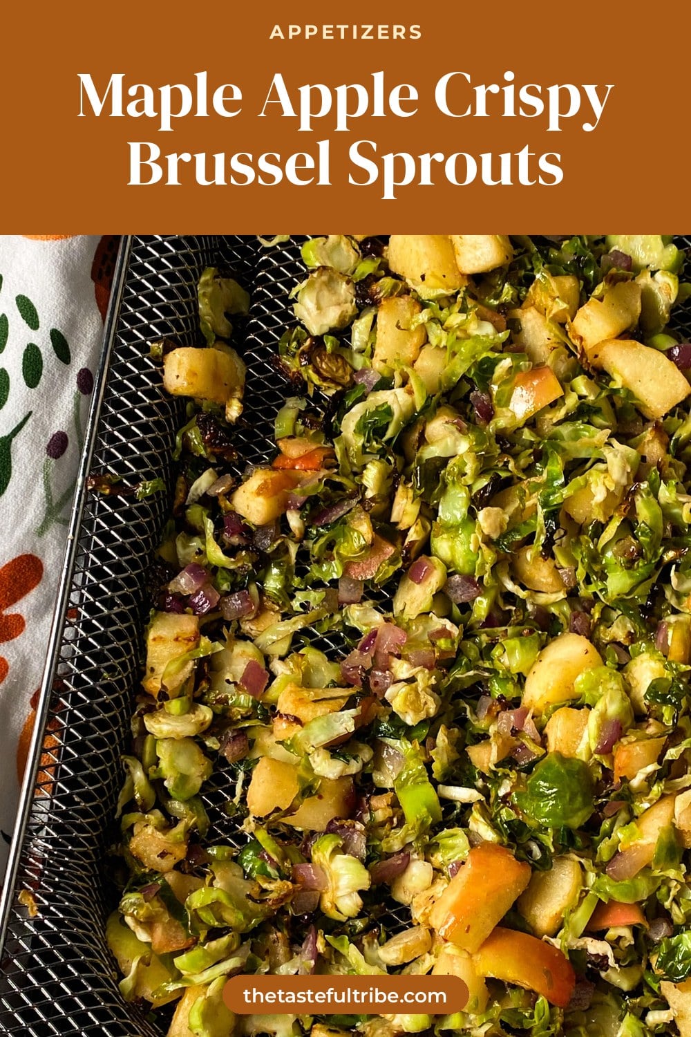 roasted shredded brussel sprouts on a air fryer pan with diced apples, red onion, and maple syrup glaze.